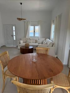 a living room with a wooden table and chairs at Anemelia by the Sea - Lipsi in Lipsoi