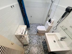 a bathroom with a toilet and a sink at Georgetown Kyash House 23 in George Town +117 photos