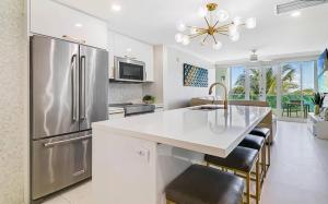 a kitchen with a stainless steel refrigerator and a counter at Oceanview Sub Penthouse, Walk to Beach & Pool in San Juan