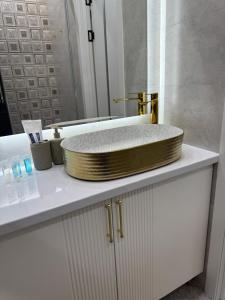 a sink on top of a counter in a bathroom at Luxury apartments Capital City in Shymkent