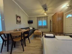 a living room with a table and a couch at 200m from Beach-Cozy Studio with Patio in Platamonas