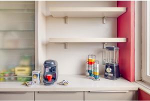a kitchen counter with a blender on a shelf at Chambre 1 Cosy & Warm in Evry-Courcouronnes
