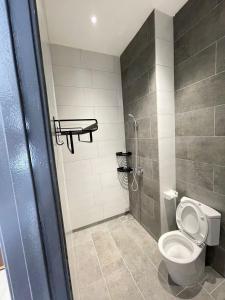 a bathroom with a toilet and a shower at The Podium opp Aeon Mall Kuching in Kuching