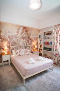 a bedroom with a bed with a flowery wall at Contessina Apt. in Corfu Town