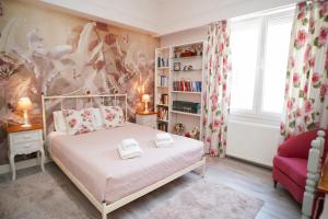 a bedroom with a bed and a book shelf at Contessina Apt. in Corfu Town