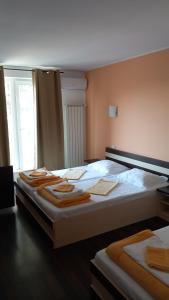 a bedroom with two beds with towels on them at Green House in Eforie Sud
