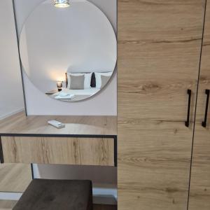 a room with a mirror and a table with a stool at Villa Yucca in Vlorë +134 photos