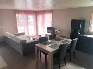 a living room with a table and a couch at Gite chez Isabelle in Villers-le-Lac +4 photos
