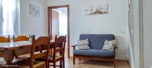 a dining room with a blue chair and a table at La Castagna Matta in Albareto