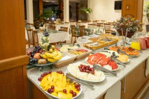 a buffet with many different types of food on a table at Hotel Prata Villaggio in Nova Prata
