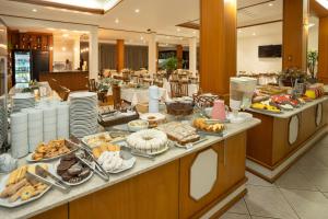 a buffet line with many different types of food at Hotel Prata Villaggio in Nova Prata