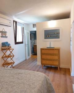 a bedroom with a bed and a dresser in a room at La Casetta in Rosignano Marittimo +27 photos