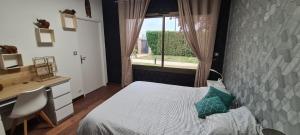 ein Schlafzimmer mit Bett, Schreibtisch und Fenster in der Unterkunft Villa Neves in Saint-Cyr-sur-Loire + 31 Fotos