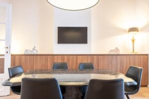 a conference room with a table and chairs at Jardin du Béguinage - Peaceful Luxury Home in Brussels in Brussels
