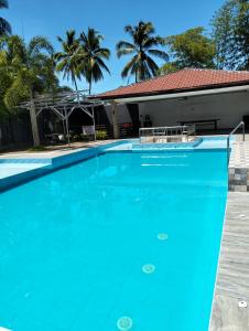 a large blue swimming pool in front of a house at Malibhu View Resort 
