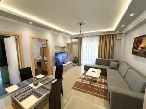 a living room with a couch and a table at Fishta Apartment Q6 37 in Velipojë +6 photos