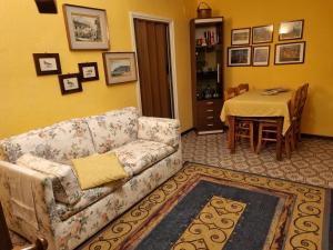 a living room with a couch and a table at LA CORTE DELLA CARLA - cozy home in the old court in Lierna