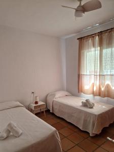 Łóżko lub łóżka w pokoju w obiekcie Las Casas de Las Flores