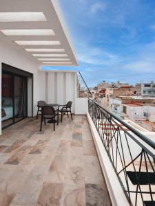 a balcony with a table and chairs and a view at Spinoza House Appart Hôtel in Casablanca