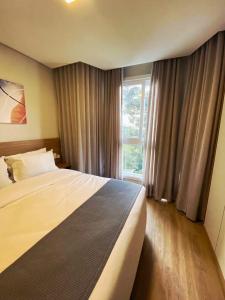 Ένα ή περισσότερα κρεβάτια σε δωμάτιο στο Encanto de Flat no Serra Class