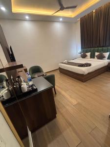 a hotel room with a bed and a desk at Hotel The Rivaaj in Rohtak
