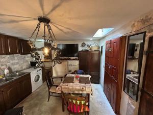 a kitchen with a table and a dining room at Michel Guesthouse in Budva