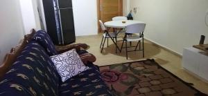 a living room with a couch and a table at grand hills in Dawwār ‘Abd Allāh