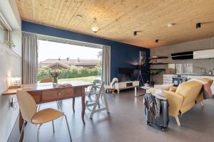 a kitchen and living room with a table and chairs at LIEBLINGSECK nachhaltige 5-Sterne Ferienwohnung - Direkt am Chiemsee in Gstadt am Chiemsee