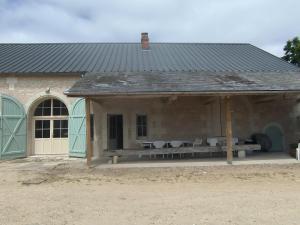 a pavilion with a bench and a picnic table at Gite la grand cour in Lencloître