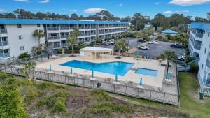 an aerial view of a hotel with a pool and a parking lot at Palm Sol in Tybee Island