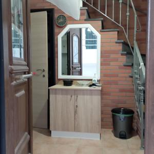 a bathroom with a sink and a mirror on a brick wall at Porto Mesta Residence in Liménas +21 photos