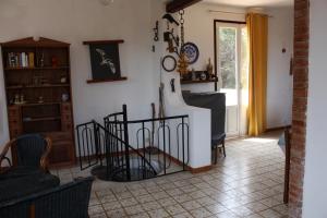 a living room with a staircase and a room with a window at Villa con Pineta tra paese e mare in Favignana