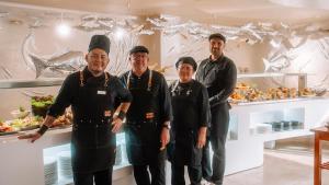 a group of chefs standing in front of a counter at Essence Hotel Boutique in Torremolinos