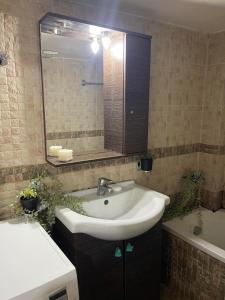 a bathroom with a sink and a mirror and a tub at Gogo's Cosy Beach House in Rethymno +48 photos