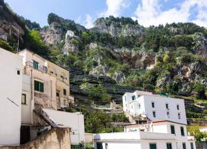 a group of buildings in front of a mountain at CristallPont AmalfiDay in Atrani