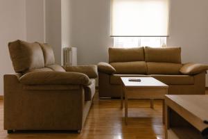 a living room with a couch and a table at Albaceteloft Avenida España in Albacete