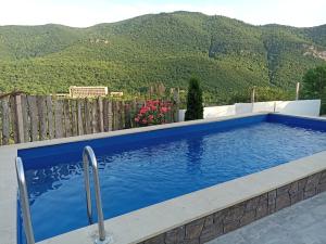 a swimming pool with mountains in the background at Green Garden in Ijevan
