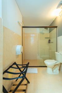 a bathroom with a glass shower and a toilet at Mandala Medellin Botero By GyC Hotels in Medellín +17 photos