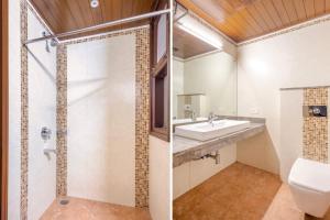 a bathroom with a sink and a shower and a toilet at Tranquil Nest in Gurgaon with balcony in Gurgaon