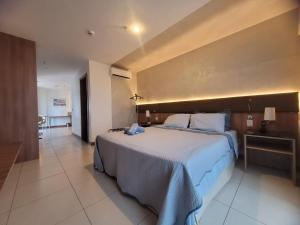 Ένα ή περισσότερα κρεβάτια σε δωμάτιο στο Flat Hotel Athos Bulcão +34 φωτογραφίες