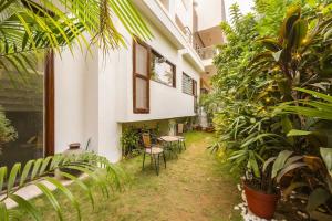 a courtyard of a house with chairs and plants at Eco-chic haven in Gurgaon with balcony in Gurgaon