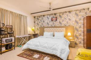 sypialnia z dużym białym łóżkiem w pokoju w obiekcie Penthouse with Jacuzzi steam bath &foot massage w mieście Gurgaon