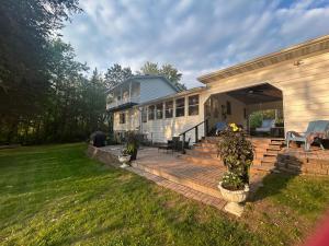 a house with a porch and a patio at Breezeway Bay - Waterfront Full House in Wisconsin Dells
