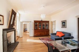 a living room with a blue couch and a fireplace at Casa Clara - Fino a 10 Posti letto in centro ad Assisi - ItalyWeGo in Assisi