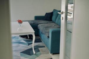 a living room with a blue couch and a table at Villa Pietra in Stolac