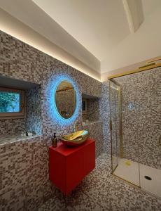 a bathroom with a red cabinet and a sink at VILLA GAETA Penthouse in Nobiallo +26 photos
