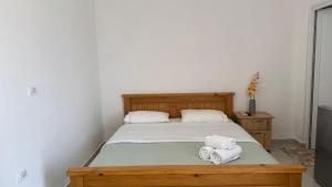 a bedroom with a bed with two towels on it at Vila Bedro in Sarandë