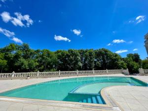 a swimming pool with a fence and trees at Coral Bay Studio Varna - Beachfront with Free Parking in Varna City