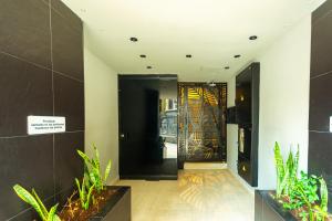 a lobby with a door with a painting on it at Mandala Medellin Botero By GyC Hotels in Medellín