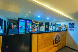 a bar in a restaurant with a counter at Mandala Medellin Botero By GyC Hotels in Medellín